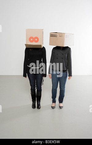 Women with boxes on their heads Stock Photo