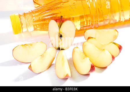 Apple slices and apple juice bottles, close up Stock Photo