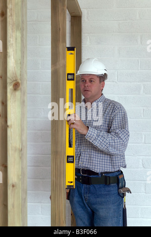 Carpenter checking a timber frame is square and level Stock Photo