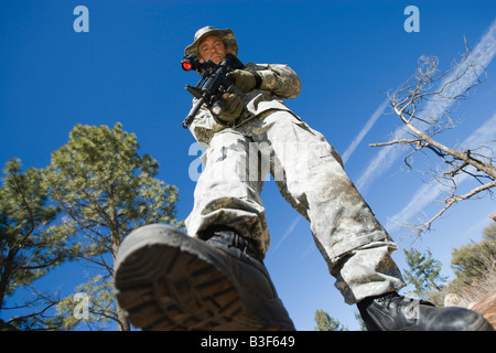 Low angle portrait of armed soldier Stock Photo