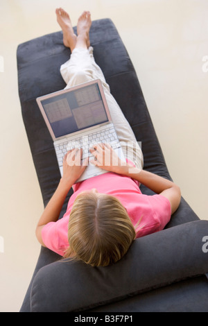 Woman sitting in chair using laptop Stock Photo