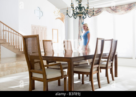 Woman in dining room smiling Stock Photo