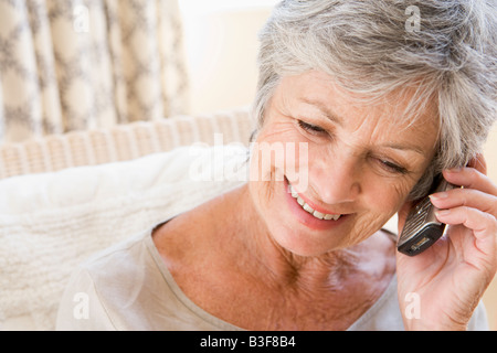 Woman indoors using cellular phone Stock Photo