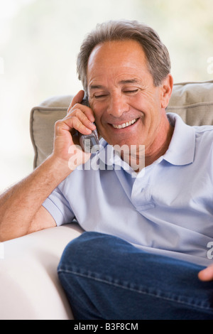Man indoors using telephone smiling Stock Photo