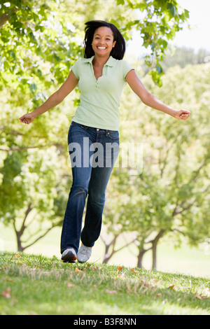 Woman running outdoors smiling Stock Photo