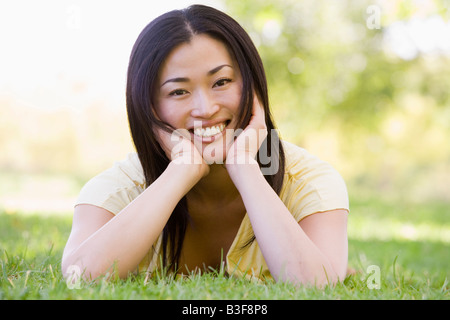 Woman lying outdoors smiling Stock Photo