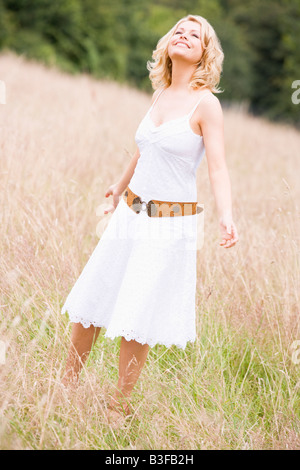 Woman standing outdoors smiling Stock Photo