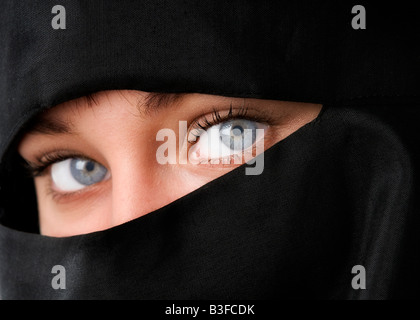 Beautiful blue eyed muslim woman in a traditional Niqab veil against a ...