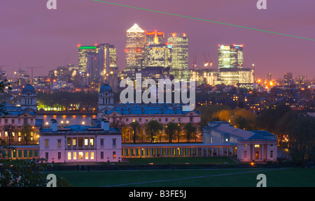 Twilight view of the National Maritime Museum and Canary Wharf from the Royal Observatory in Greenwich with the meridian Laser Stock Photo