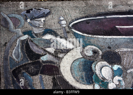 Fading graffiti jester or clown on cement pavement of Queen Street West in Toronto Stock Photo
