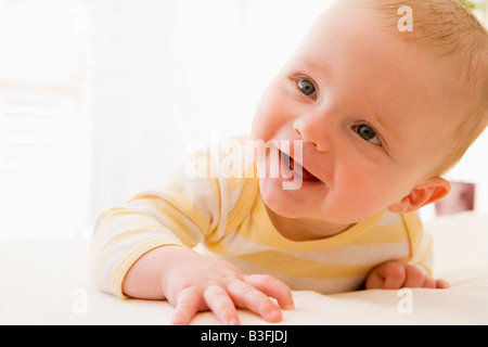 Baby lying on bed Stock Photo