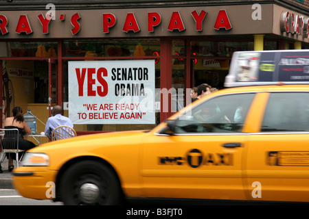 New York taxi passing Barack Obama sign Stock Photo