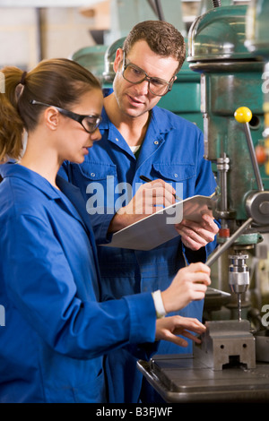 Two machinists working on machine Stock Photo