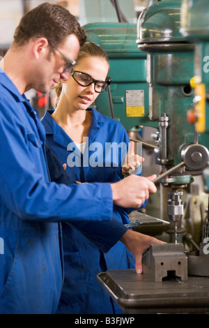 Two machinists working on machine Stock Photo