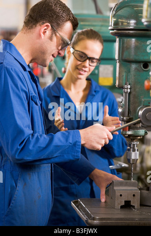 Two machinists working on machine Stock Photo