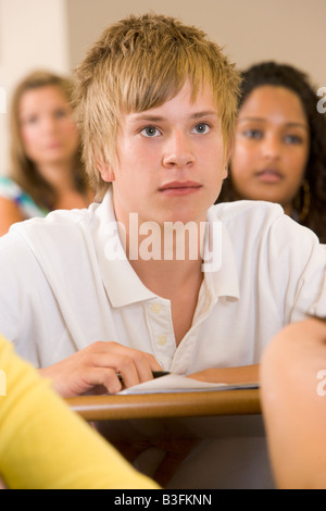 Student in class taking notes (selective focus) Stock Photo