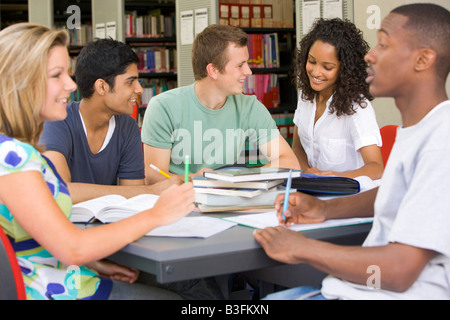 Five people in library studying (selective focus) Stock Photo