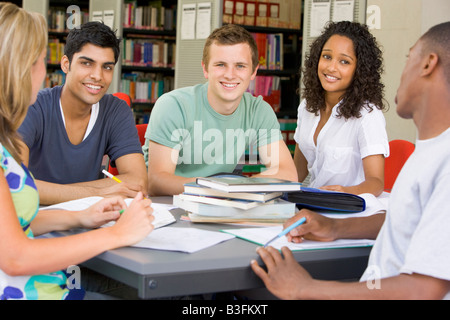 Five people in library studying (selective focus) Stock Photo