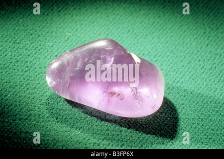 Amethyst, polished pebble on green cloth Stock Photo