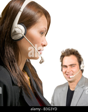 Asian woman and caucasian man with headsets in call center Stock Photo