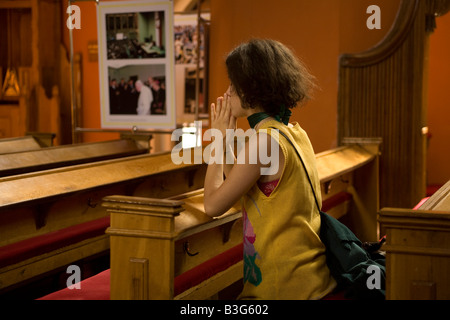 Young woman prays in a Catholic church in Zielona Gora Poland Stock Photo