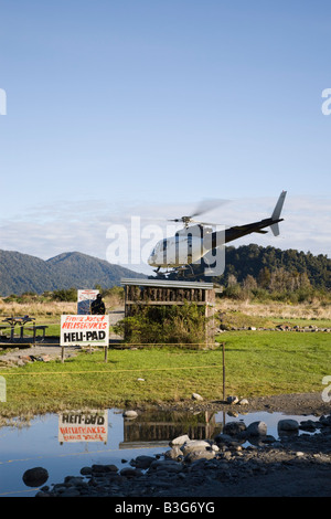 Franz Josef New Zealand Heliservices Heli pad helicopter taking off for tourist's sightseeing flights over Southern Alps Stock Photo