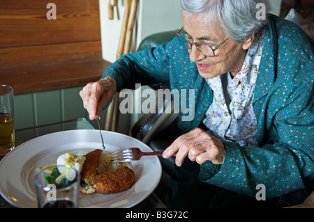 Active woman of 92 years eating meal out in English pub Stock Photo