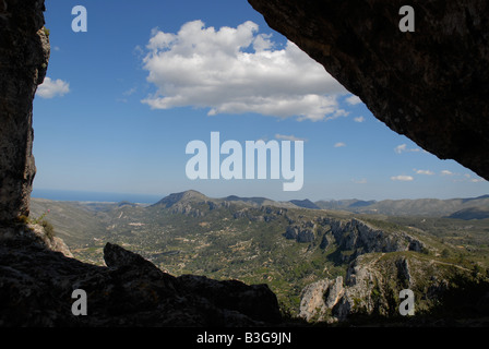 view through Forada Rock Arch, Sierra de la Forada, Alicante Province, Comunidad Valenciana, Spain Stock Photo