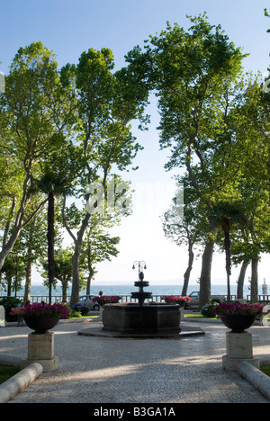 Lake side and tree lined avenue leading to the lake at Bolsena in Lazio, Italy Stock Photo