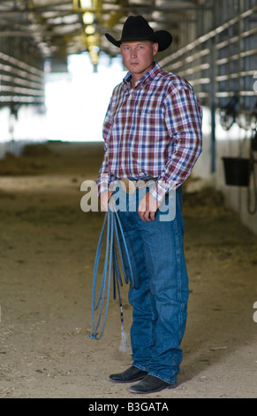 Idaho. A cowboy stands in a corral at a rodeo with his rope. Stock Photo