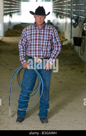 Idaho. A cowboy stands in a corral at a rodeo with his rope. Stock Photo