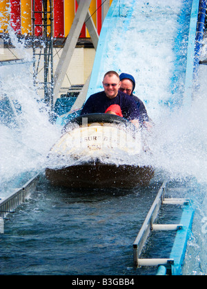 Family having fun on the Log flume at Skegness seafront amusement park Lincolnshire England UK Stock Photo