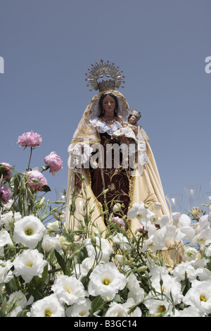 The effigy of Nuestra Senora del Carmen patron of Spanish fishermen is taken to the port, fiesta in Playa San Juan, Tenerife Stock Photo