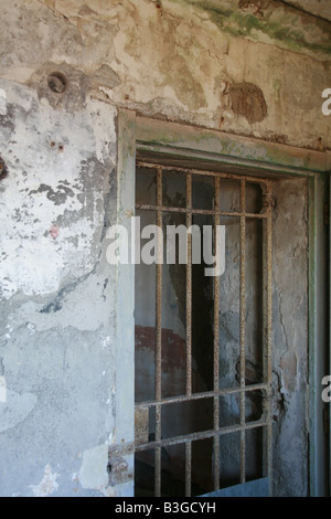 one old derelict prison cell with metal bar door Stock Photo