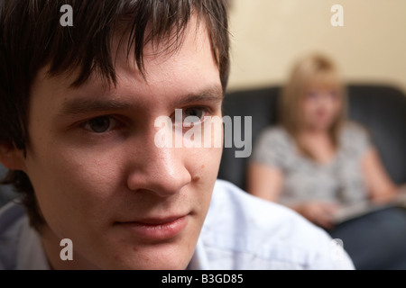 young man and woman couple sitting in the living room bored Stock Photo