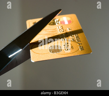 Credit card being cut by scissors Stock Photo