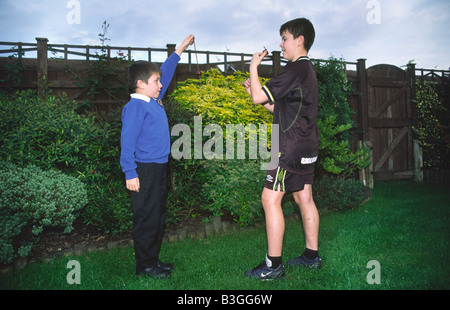 Two boys playing the traditional game of Conkers Stock Photo