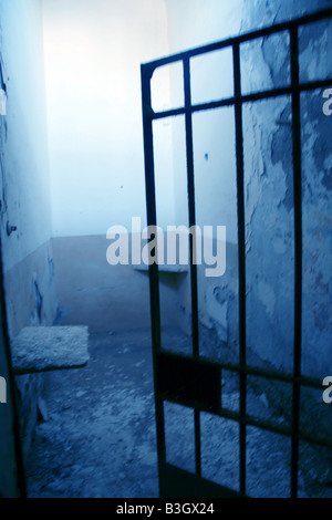 one old moody dark derelict empty prison cell Stock Photo