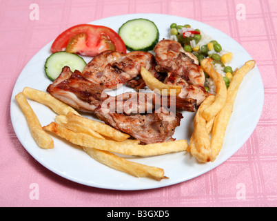A grilled rabbit served with french fries rice and vegetables in a taverna restaurant Rabbit is a favourite meat for the Greeks Stock Photo