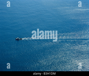 small fisherboat crossing the wide mediterranean sea kleines Fischerboot im weiten Meer Mittelmeer Gozo near Malta Stock Photo