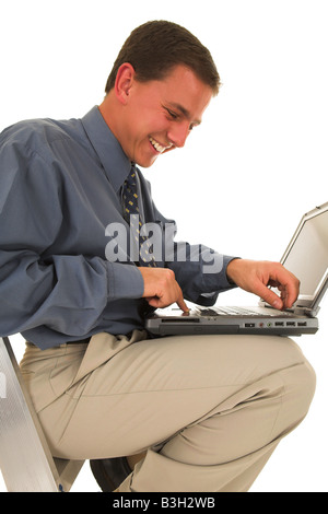 Man laughing while he is working on laptop Stock Photo