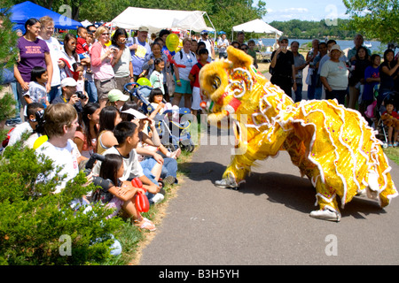 Dancing dragon performing in front of attentive audience. Dragon Festival Lake Phalen Park St Paul Minnesota USA Stock Photo