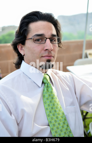 A 30 year old Hispanic man with a goatee wearing glasses at an outdoor afternoon picnic in Penrose, CO, USA. Stock Photo
