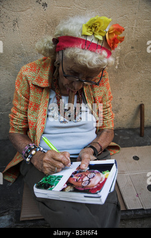 The local lady who appeared on the inside of a Lonely Planet Cuba signs a copy for a tourist in Havana in Cuba. Stock Photo