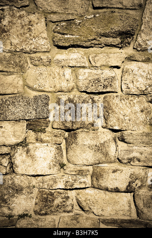 Old stone wall with a grungy sepia tone Stock Photo