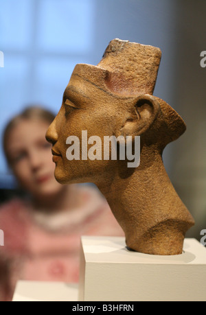 Young visitor looking at the bust of Queen Nefertiti in the Egyptian Museum in Berlin, Germany Stock Photo