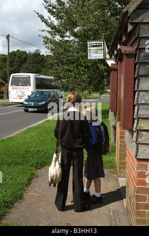 Children waiting at bus stop outside a bus shelter Stock Photo ...