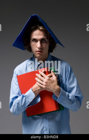 Young man with files on his head Stock Photo
