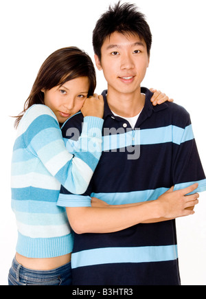A young asian couple in casual clothing on white background Stock Photo
