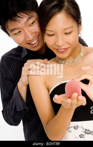 A young woman is given a ring by her man Stock Photo